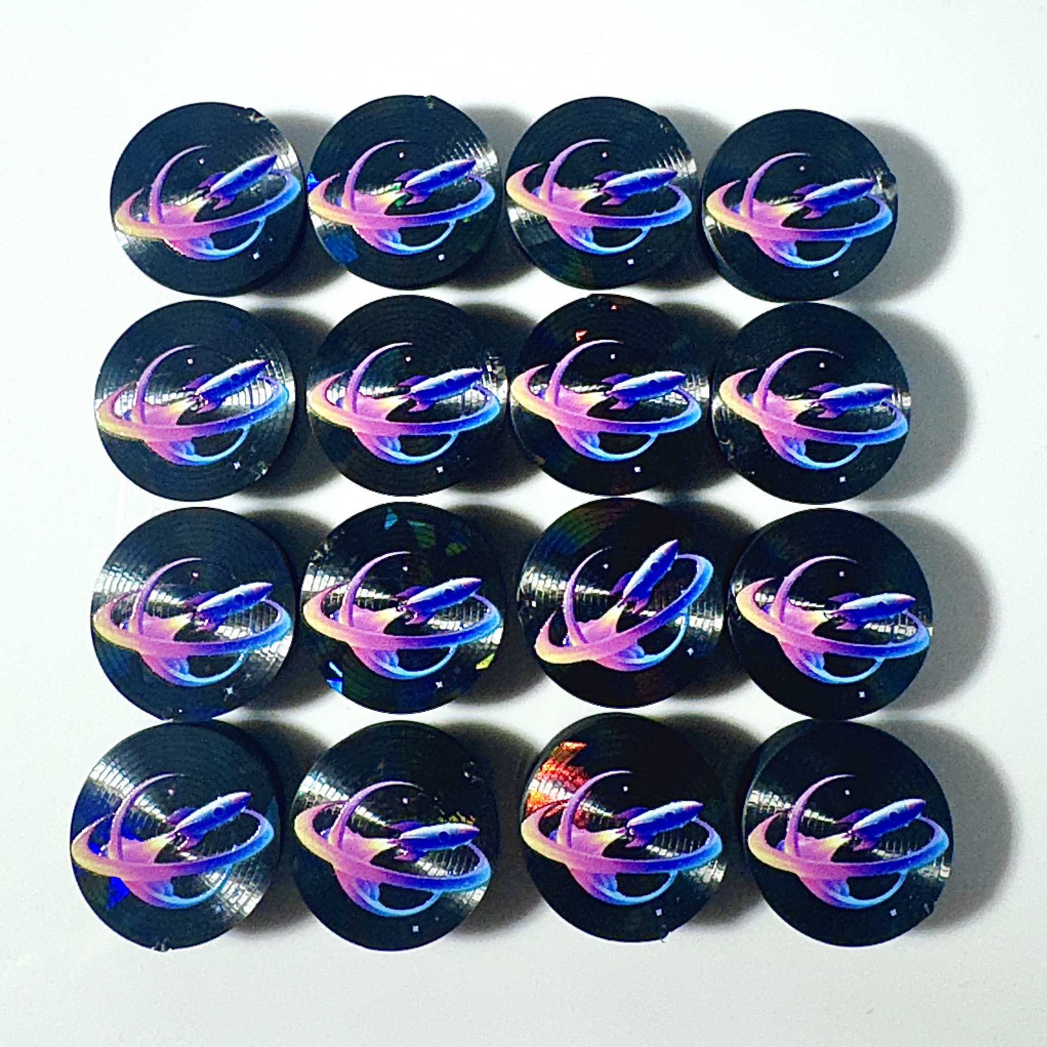 Black vial caps with a full-color holographic galaxy logo UV-printed on top